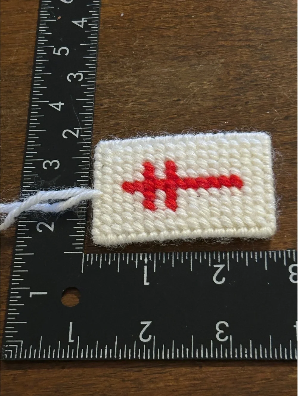 Handmade White Woolen Ornament with Red Cross Stitch